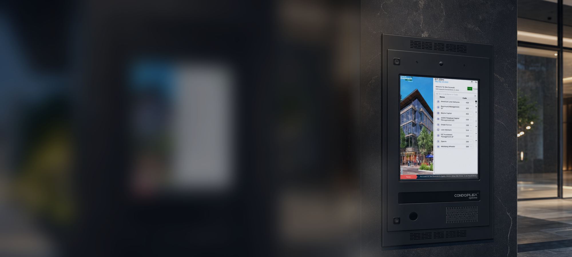 Condoplex wall-mounted entry panel at a lobby entrance at night